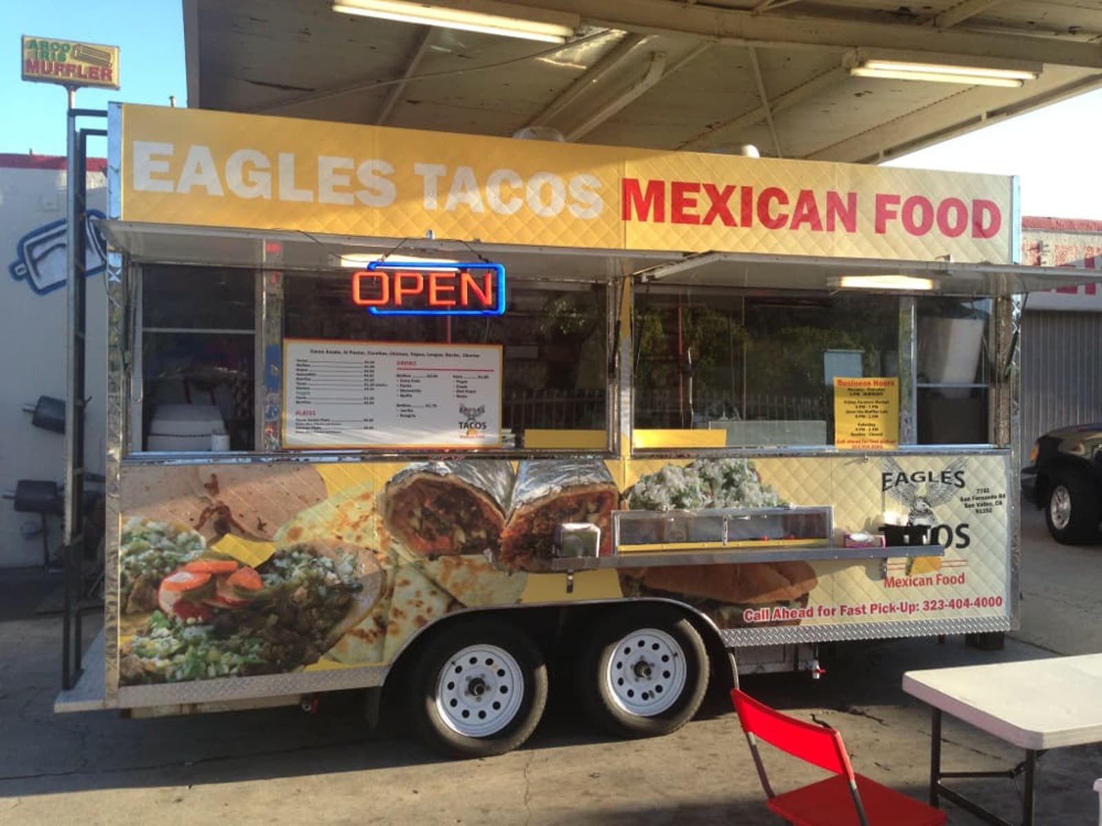 Eagles Tacos service window and open sign